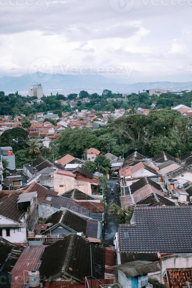 Dense Residential Area with Red Tiled Roofs and Mountain Backdrop photo