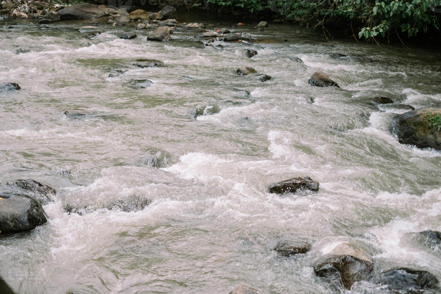 Rocky river flows powerfully through nature landscape environment photo