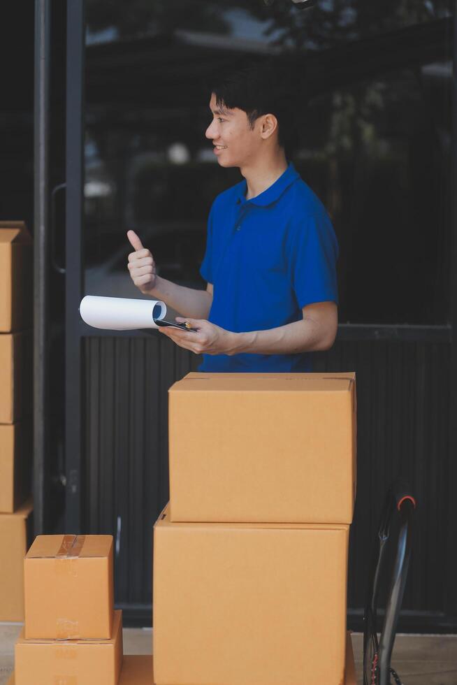 A man in a blue shirt is holding a clipboard and pointing at something photo