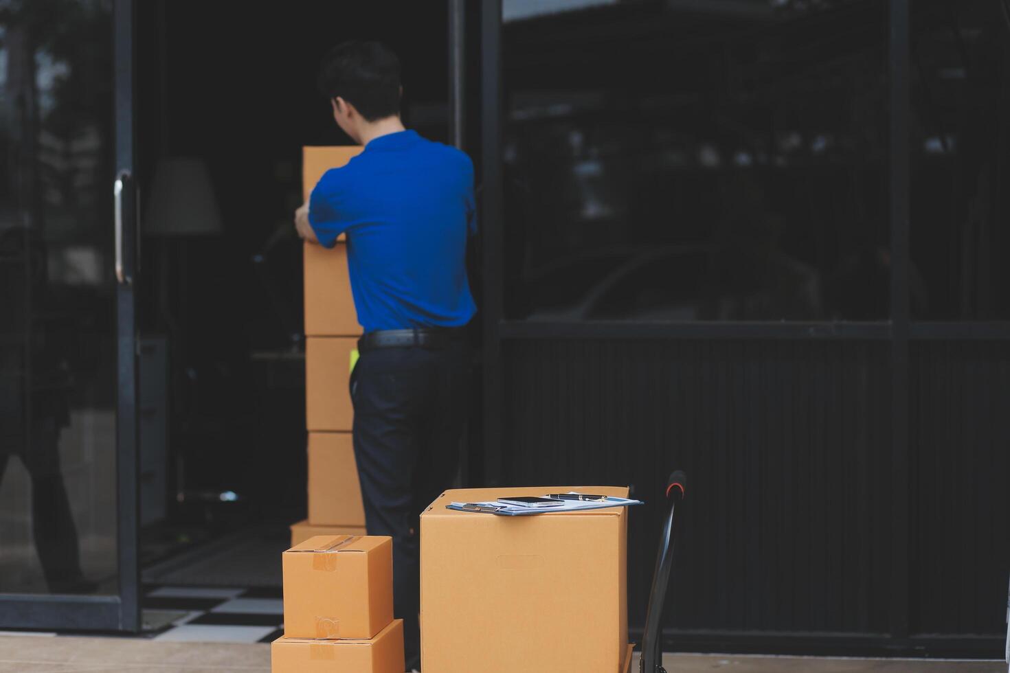 A man is moving boxes into a building photo
