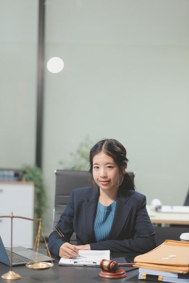 A woman in a business suit sitting at a desk photo