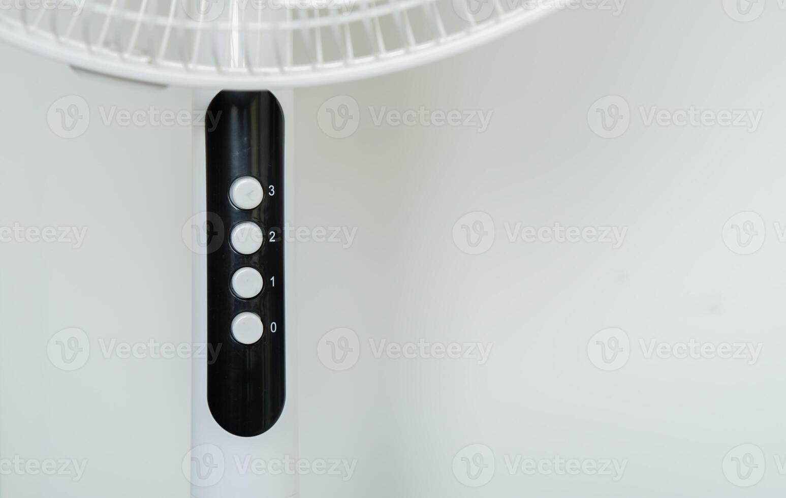 Cropped image of white modern electric fan in room and selective focus on the number. photo