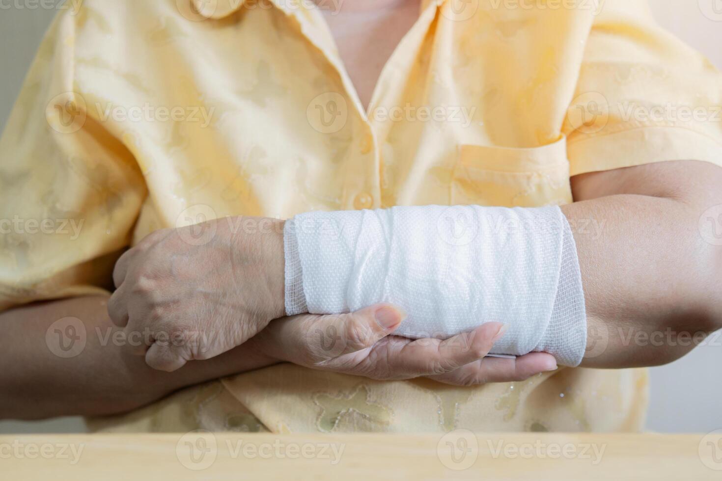Close-up bandaged arm of a old woman because of a skin lesion. photo