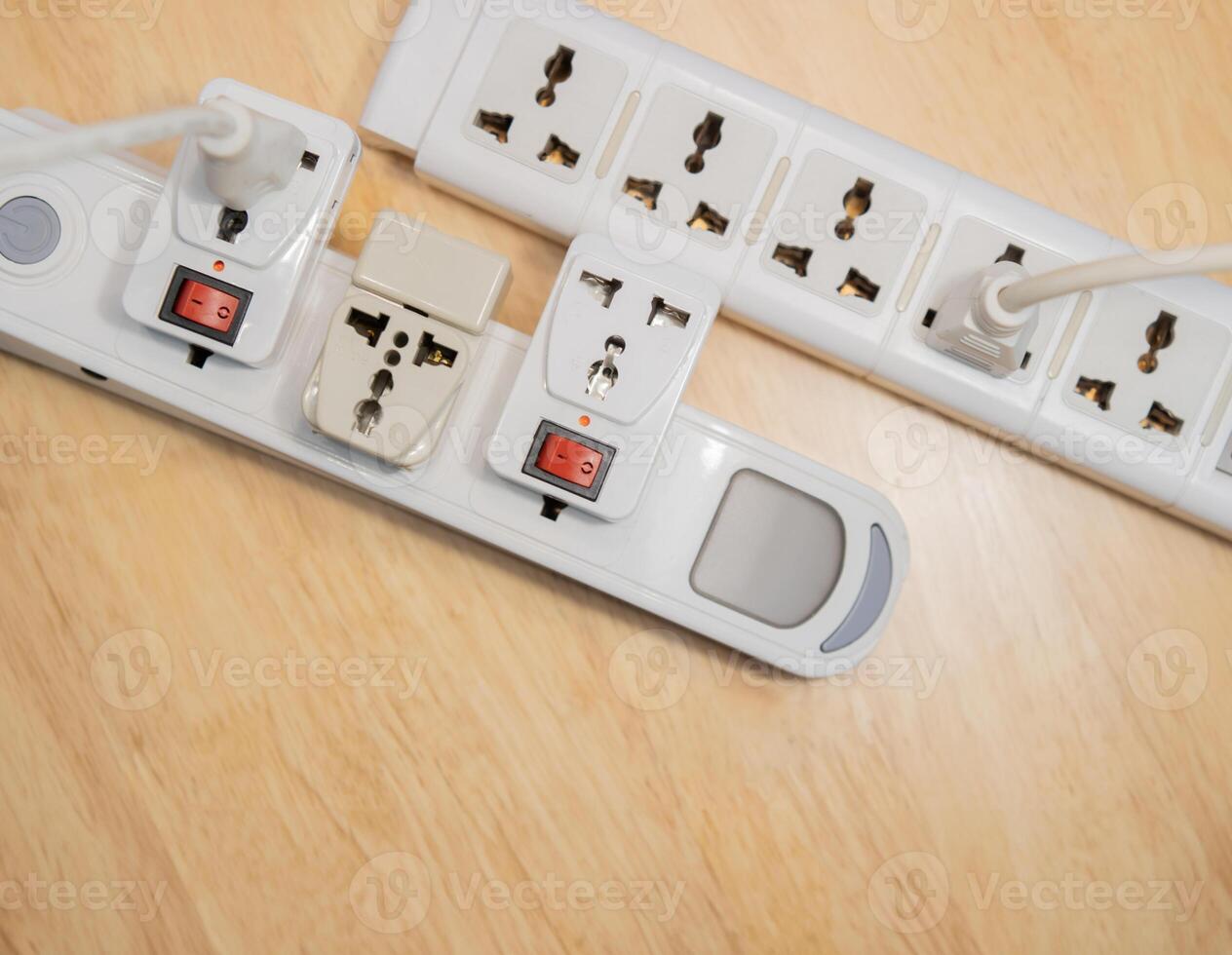 Top view of plugs in extension cords - from the Offset collection on wooden table. photo