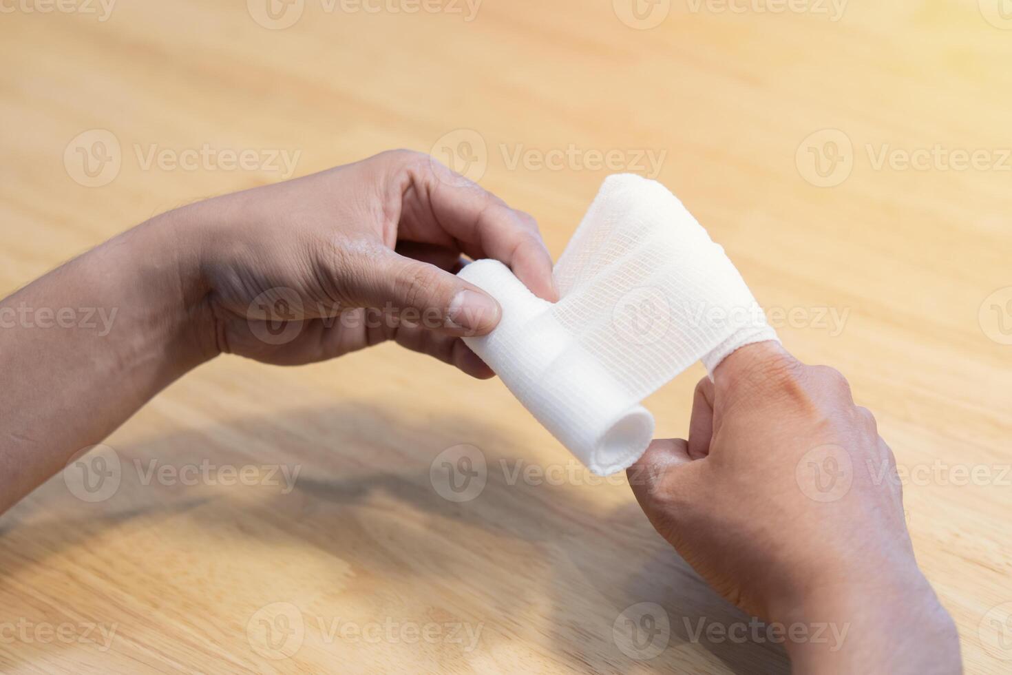 Close-up photo of man' s finger with bandaged. First aid in case of small domestic injury.