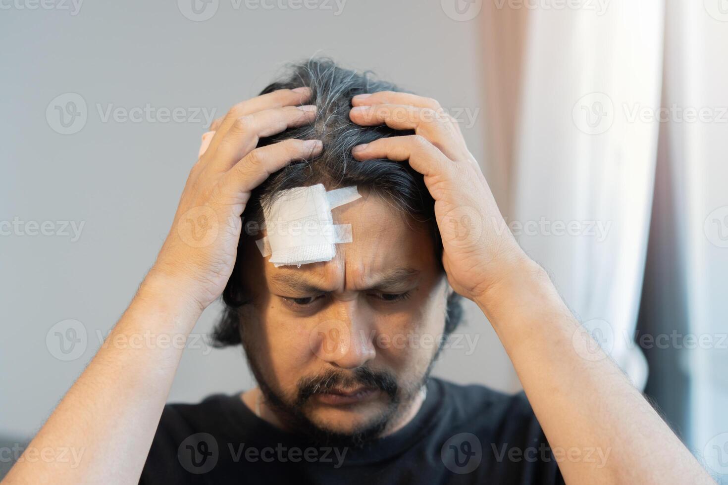 Portrait image of handsome man feel worried and hurt with injured forehead photo