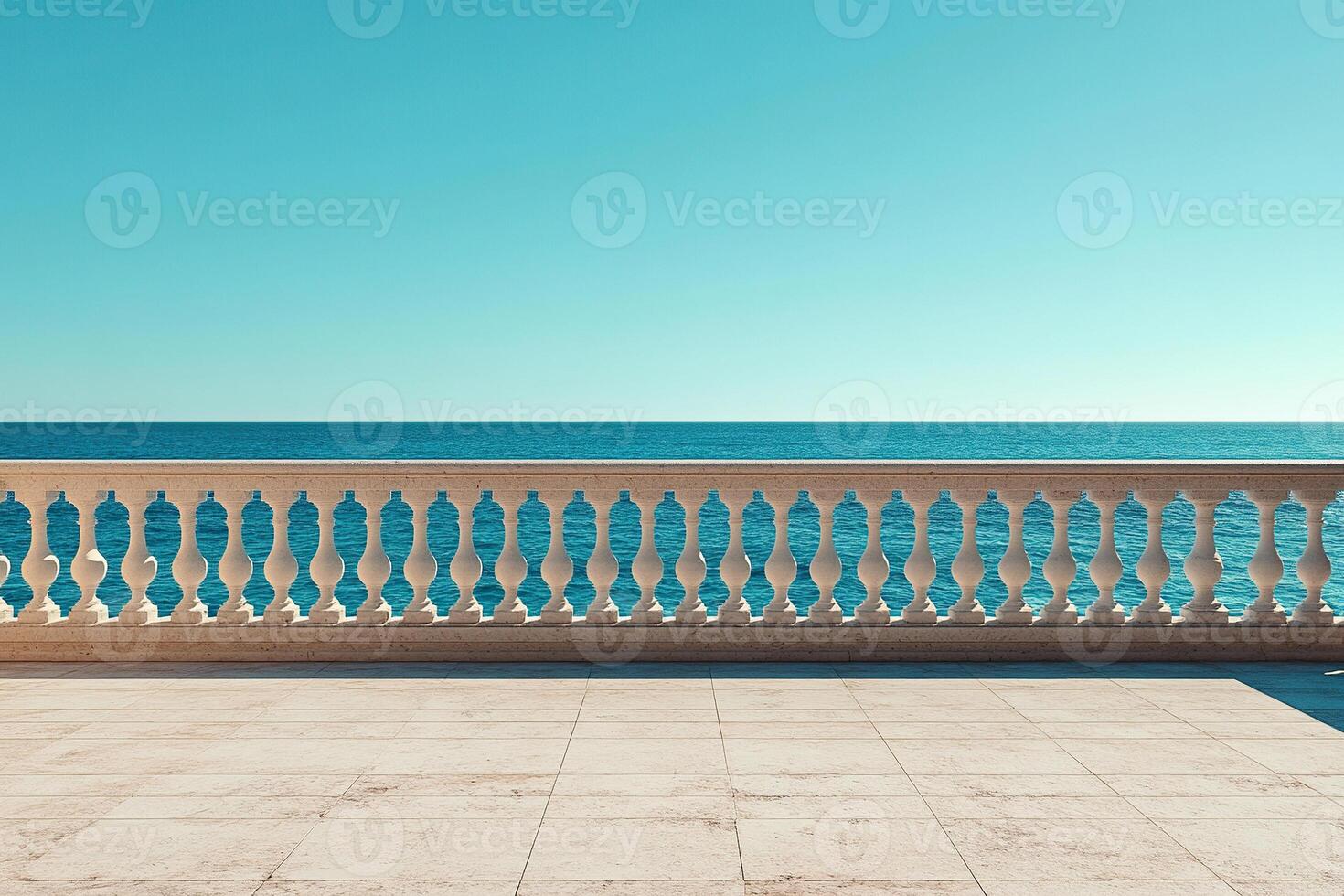 An empty observation deck with a white fence and columns overlooking a calm ocean on a sunny day. photo