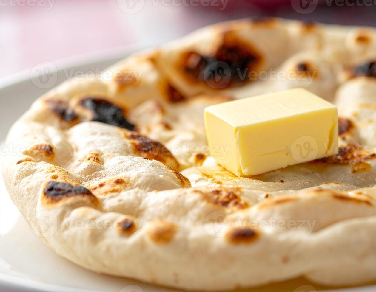 Soft Puffed-Up Tandoori Roti Served with Fresh Butter for an Authentic Taste photo