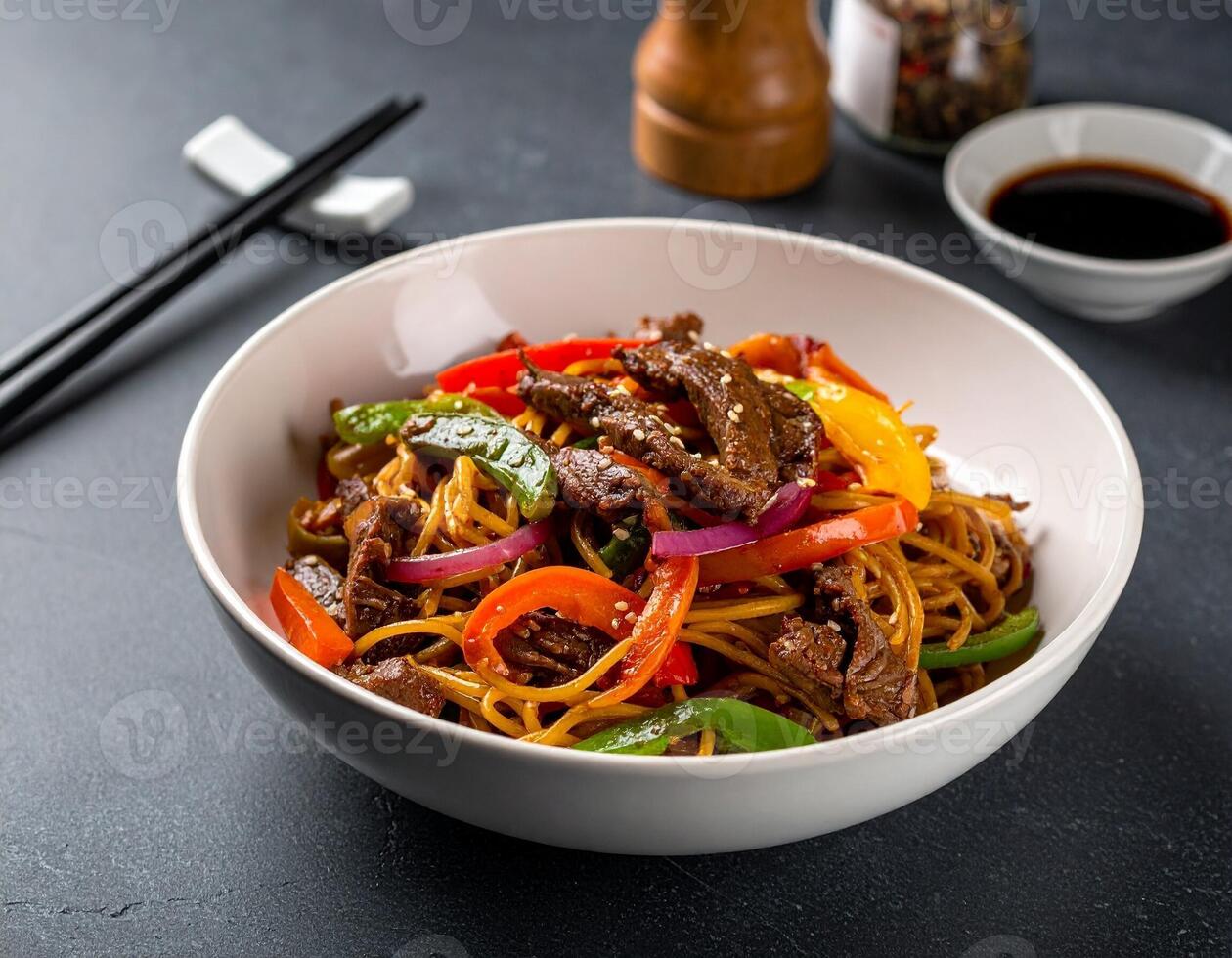 Beef Chow Mein with Colorful Bell Peppers and Onions in a Deep Ceramic Bowl photo