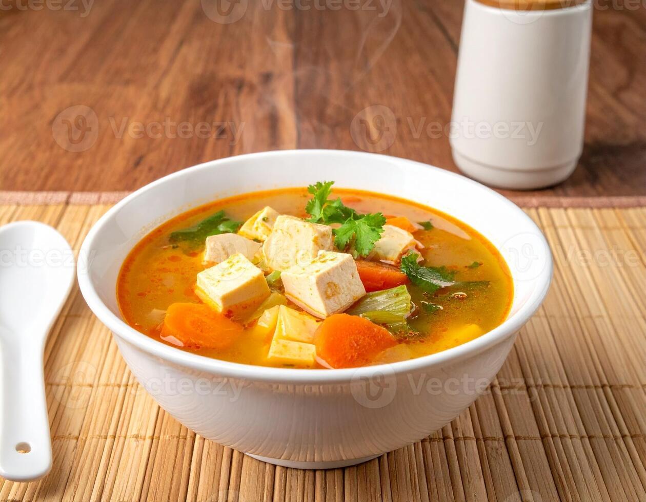 Rich and Spicy Hot and Sour Soup with Tofu and Vegetables, Steam Rising photo