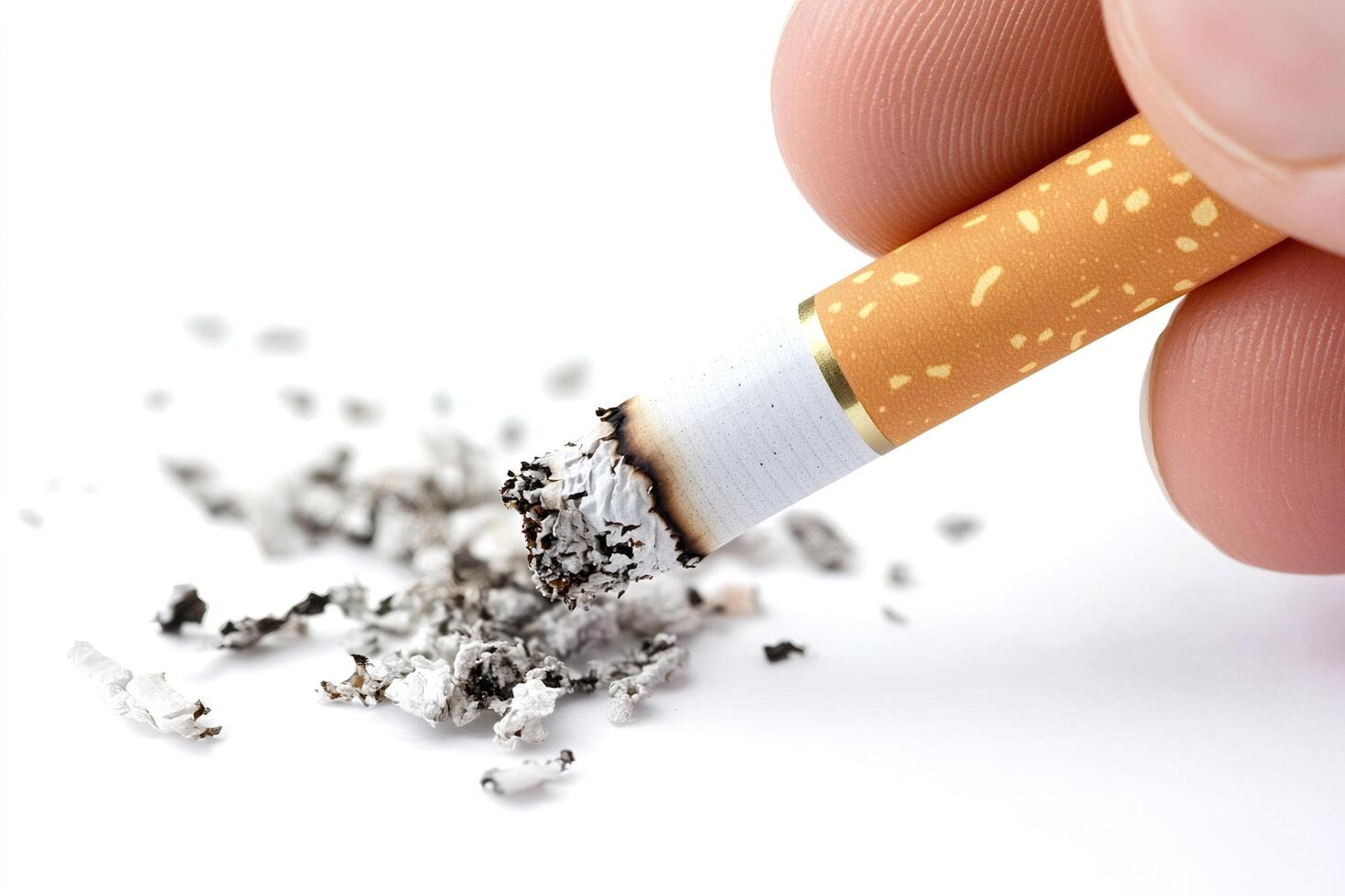 Fingers holding burning cigarette with ash on white background photo