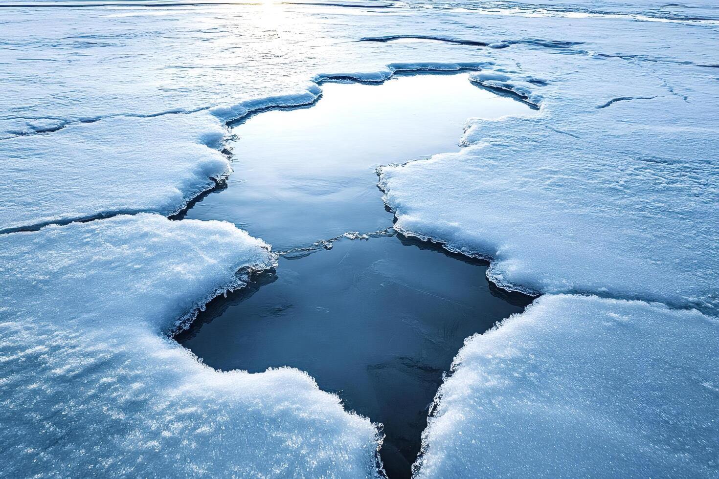 Melting ice forming abstract shapes on frozen lake surface photo