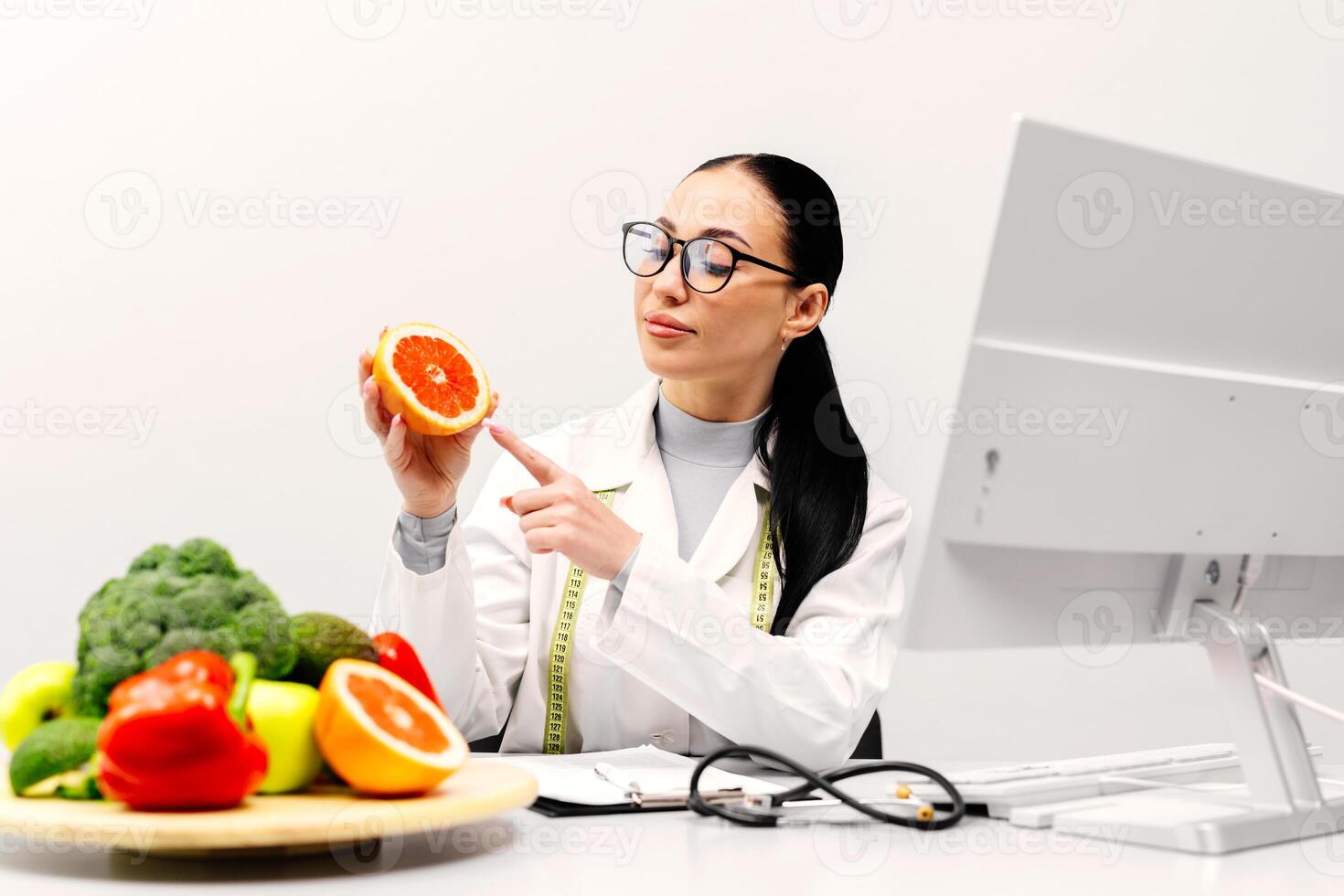 Young Dietitian writing diet plan, view from above on table with different healthy products. Weight loss and right nutrition concept. White background photo