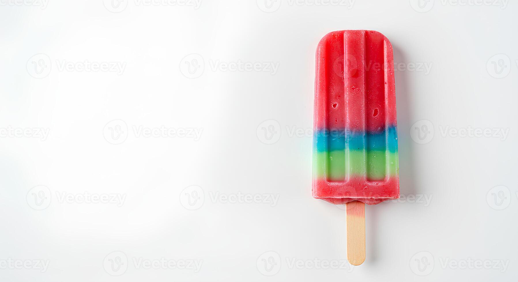colorful fruit flavored popsicle isolated on white background with shadow. ice popsicle as treat during summertime heats. fruity dessert photo