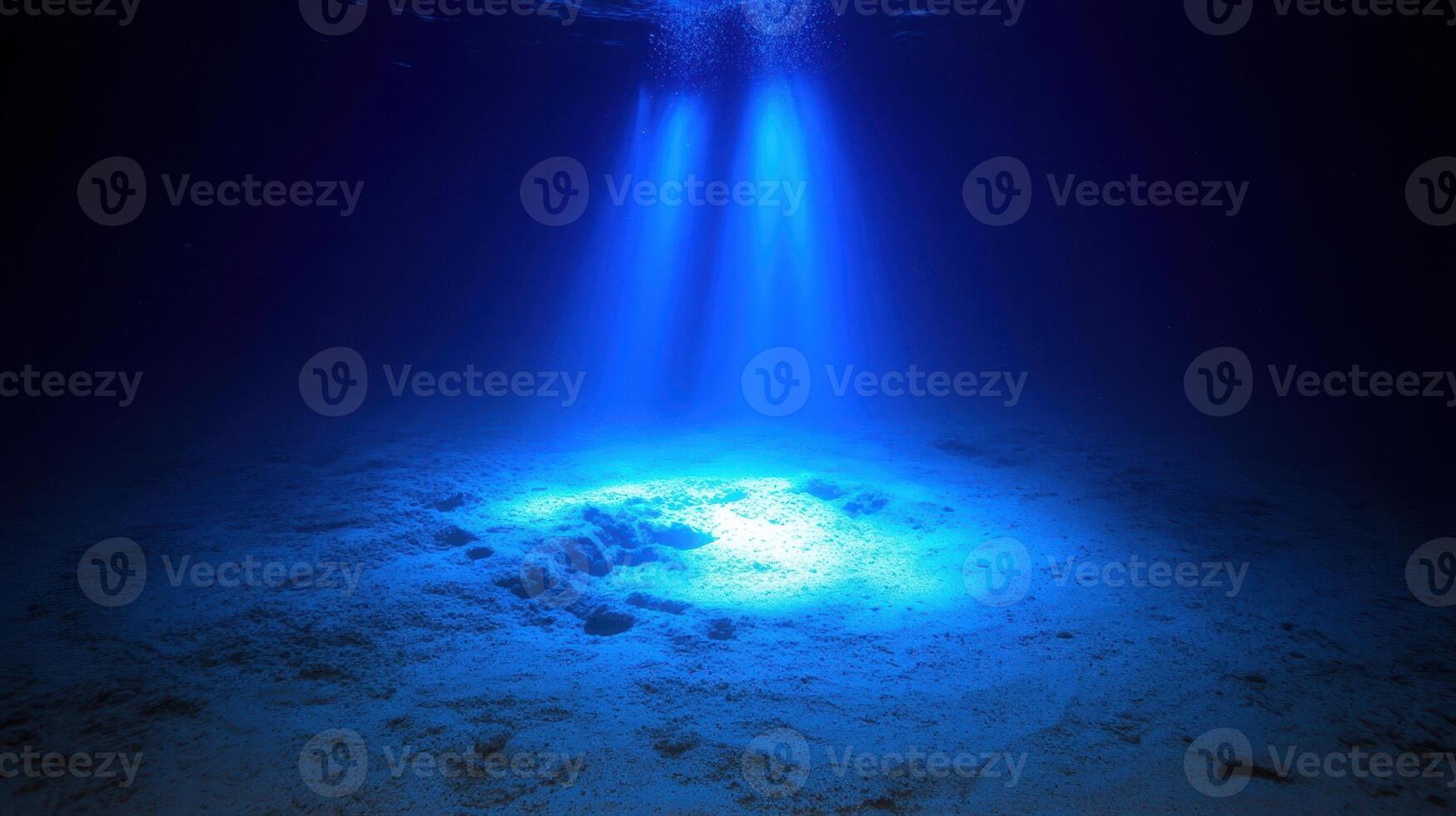 Ocean Depth Sunlight Piercing Through Submerged World of Serenity and Enigmatic Beauty photo