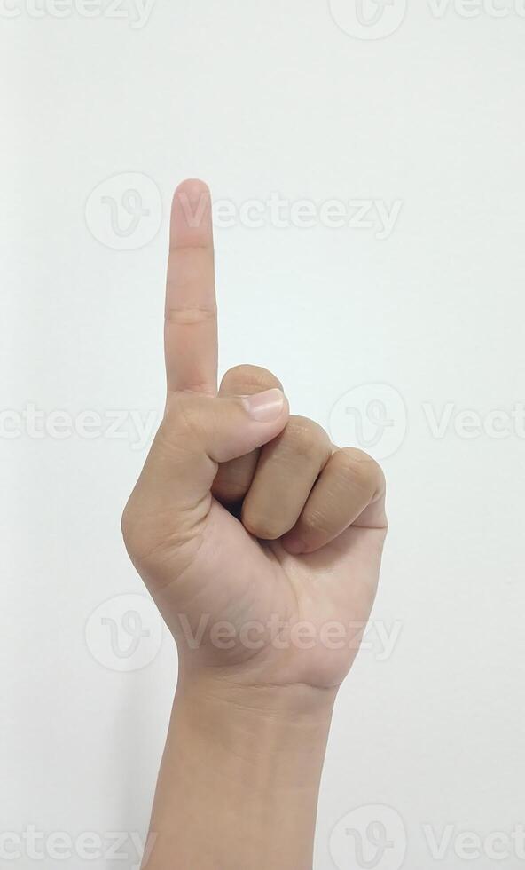 Close up Asian female 20 age hand show Number one finger, sign arm and hand isolated on a white background copy space symbol language photo