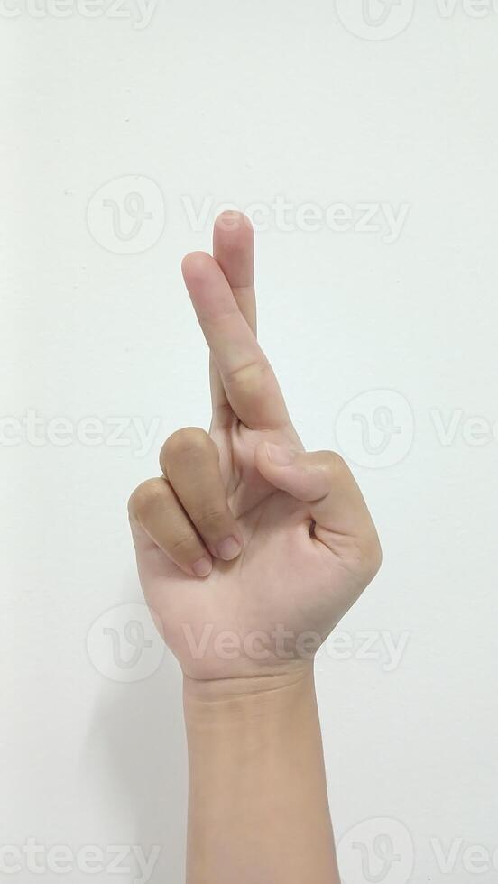 Close up Asian female15 20 age hand show two fingers rim light for lie and wishing, for good luck gesture, sign arm and hand isolated on a white background copy space symbol language photo
