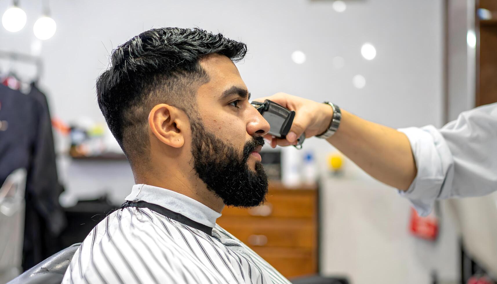 A professional barber cutting hair with precision in a sleek, contemporary salon environment photo