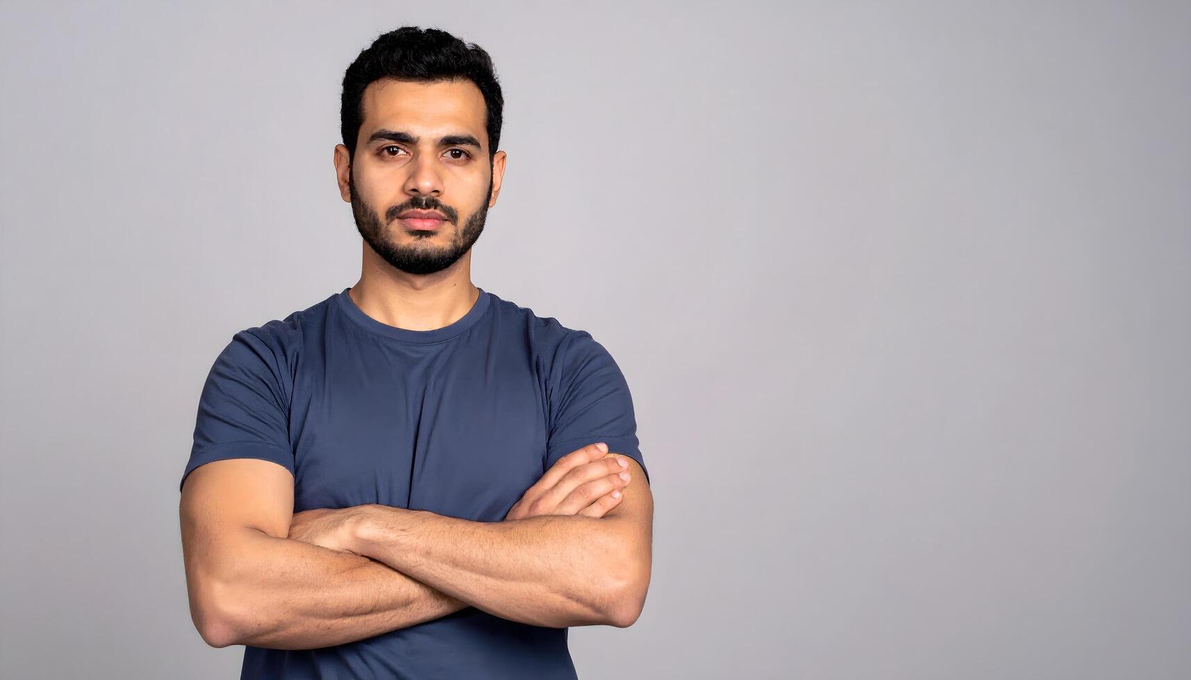 Portrait of a confident man with arms crossed and a serious expression photo