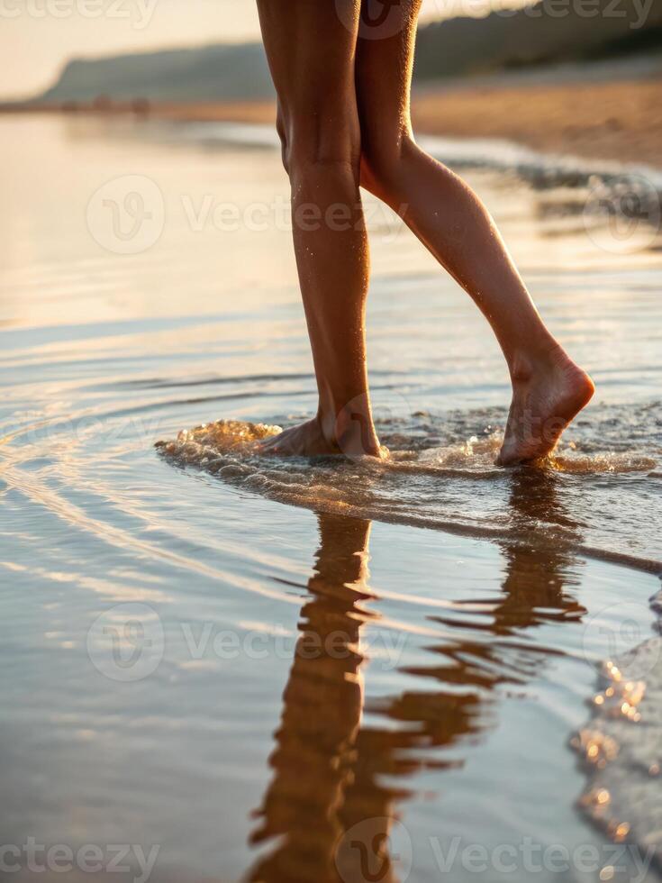 Walking barefoot along the shoreline at sunset with soft waves lapping at the feet photo