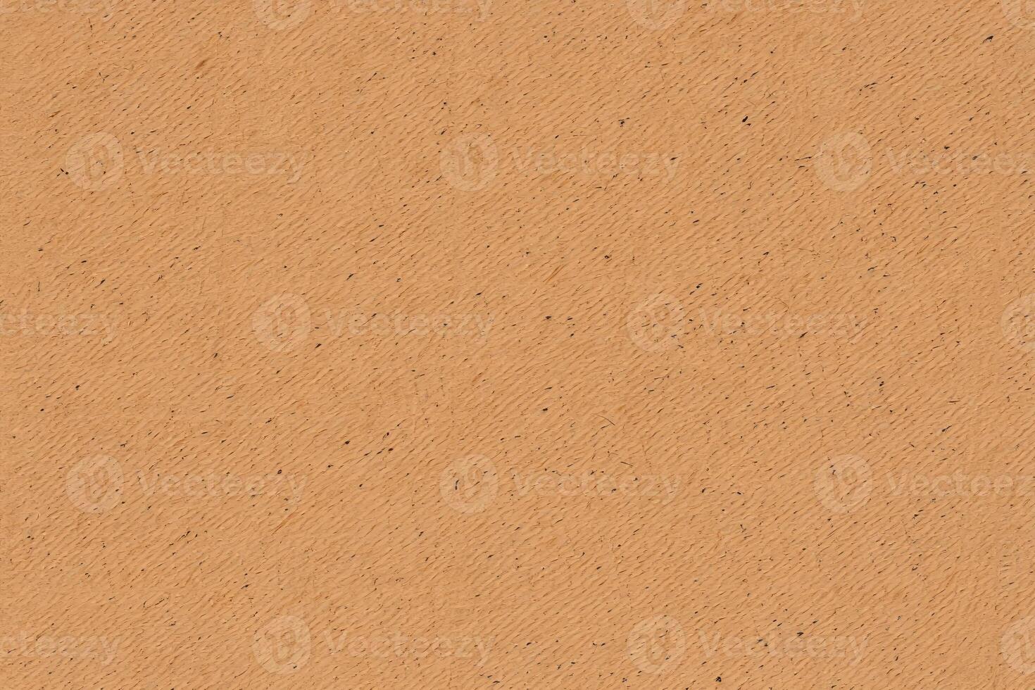 Texture of natural paper showing a warm orange hue with a subtle pattern and grain detail photo