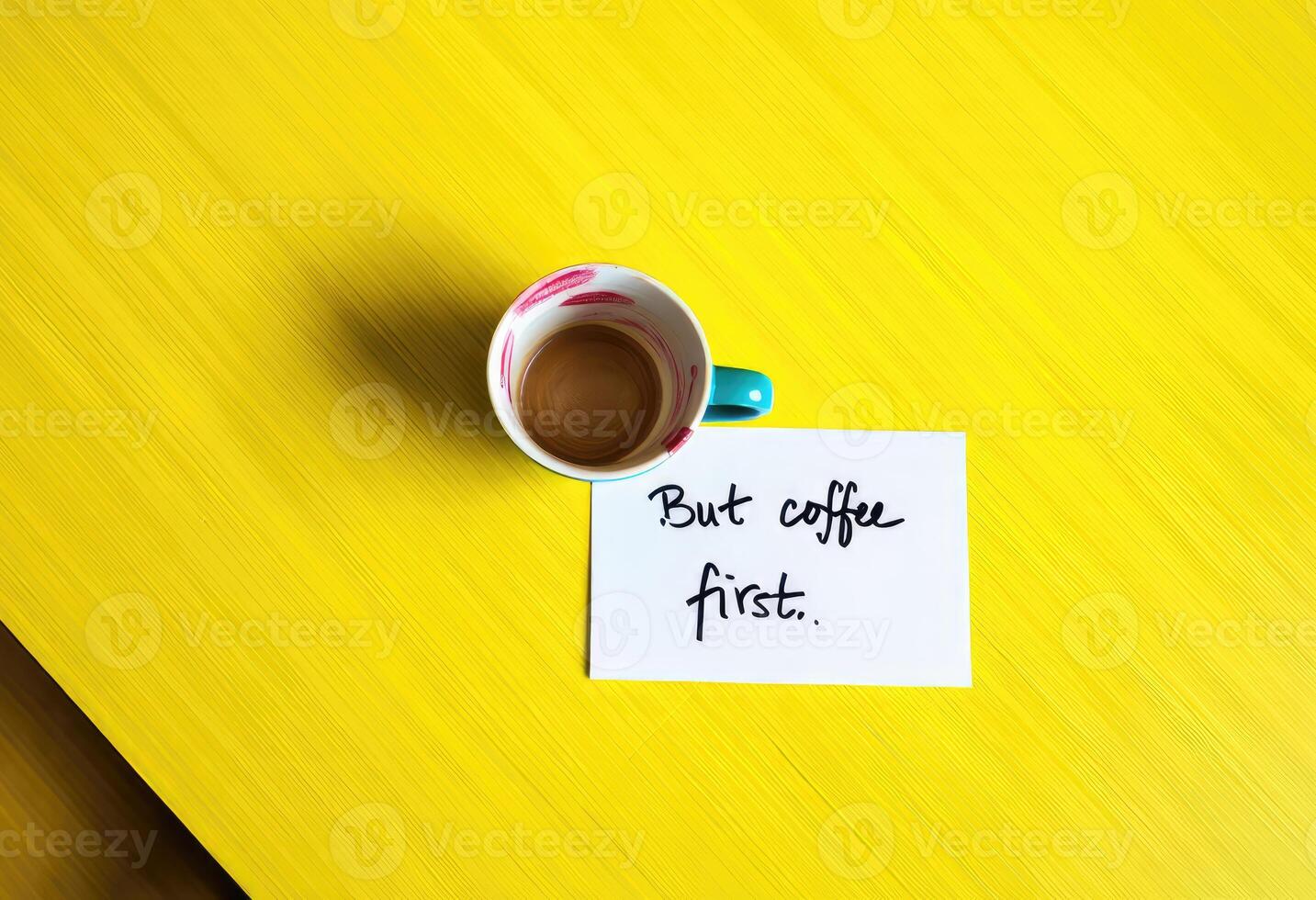 Enjoying coffee on a bright yellow table with a handwritten note about priorities photo