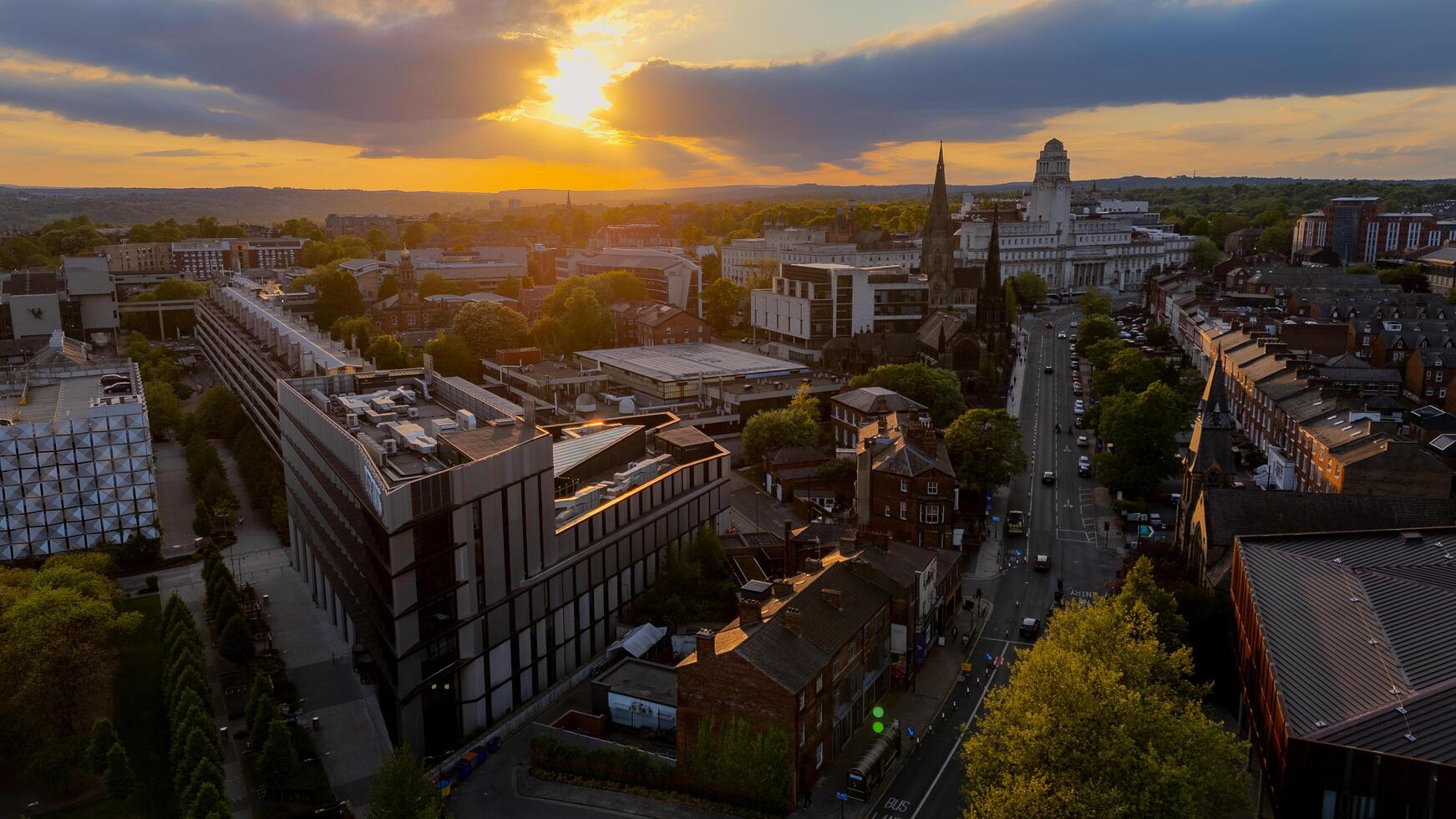 07-05-2025 Leeds, United Kingdom. Leeds city center skyline shining during golden hour sunset photo