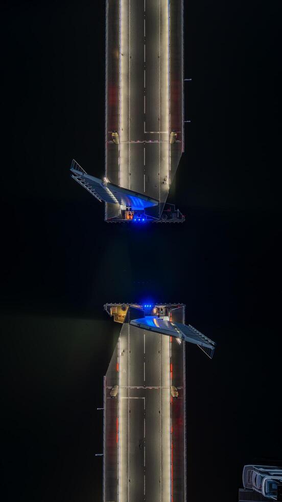 28 April 2025 Poole, Uk. Twin Sails Bridge opening at night in Poole, UK photo