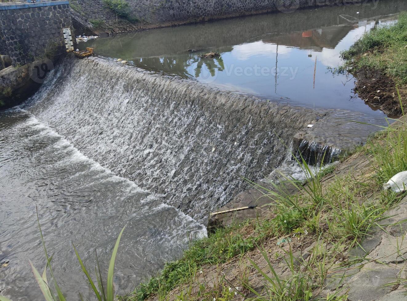 River dam located in the middle of a residential area photo