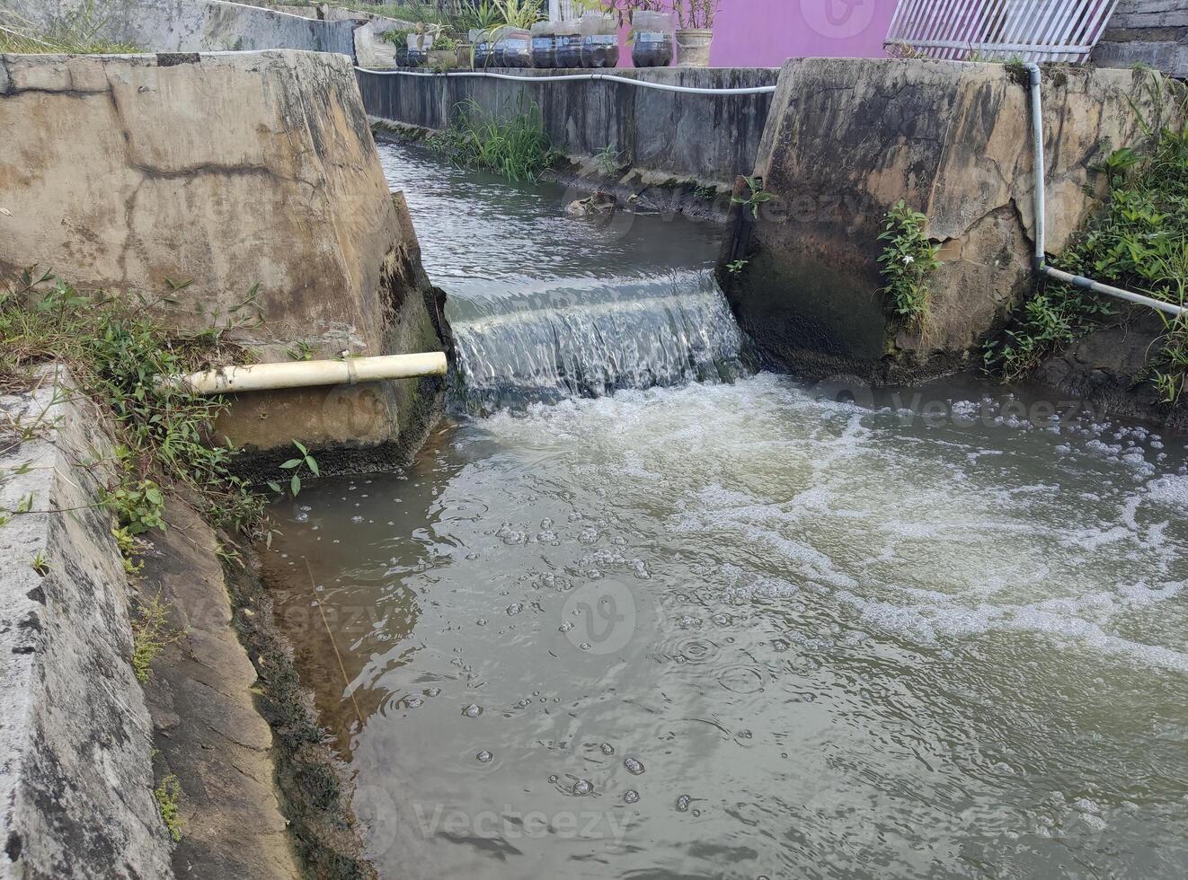 River water flows from the dam to agricultural land photo