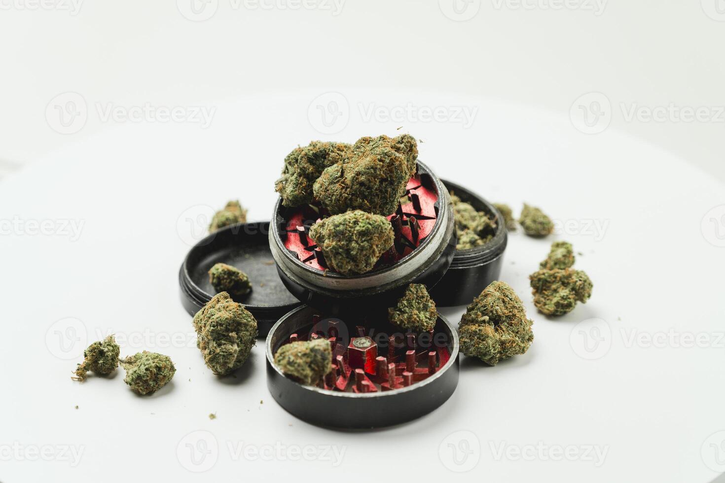 Medical marijuana buds with grinder on white background, close up. Concept of alternative medicine photo