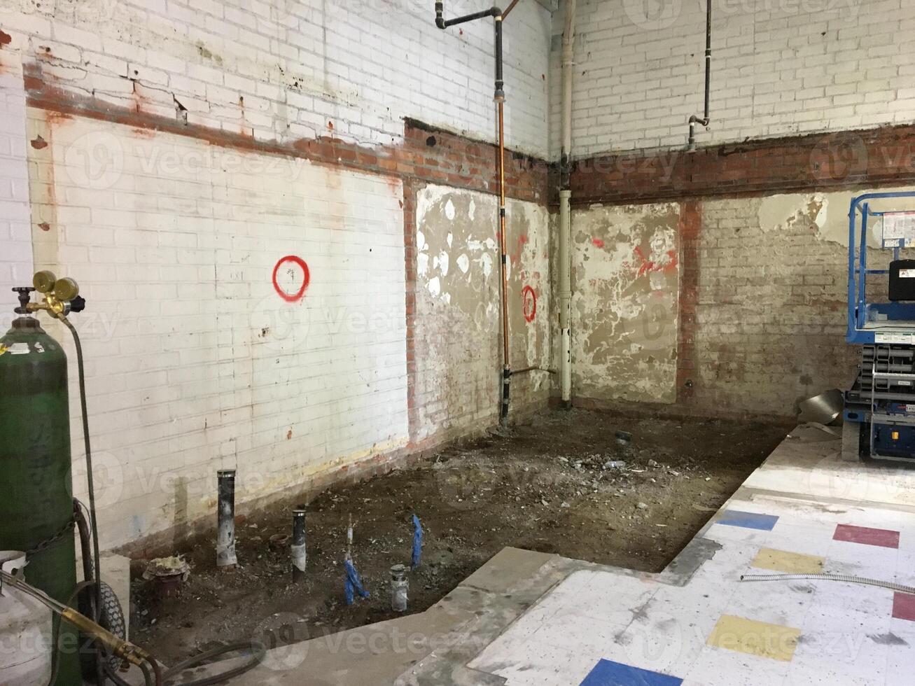 A Retail Store Having a Big Remodel with the Floor Dug Up and Walls Torn Down photo