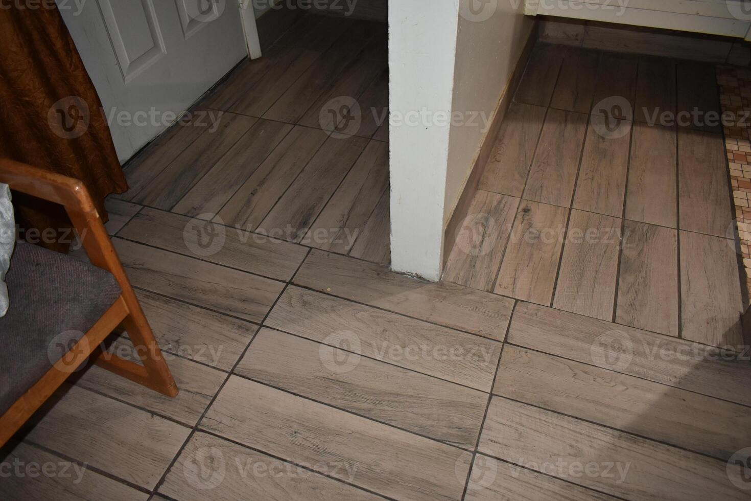 Bad Floor Tile Work, Construction Project with Wood Colored Tiles photo