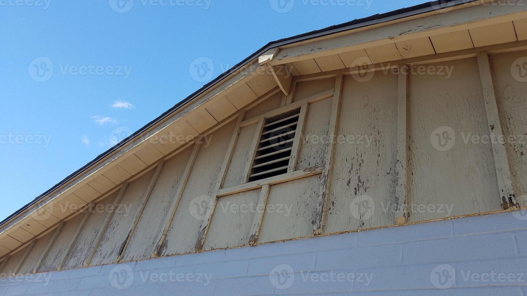 Scraping Flaky Peeling Paint on Old Home, Getting Ready to Paint a House photo