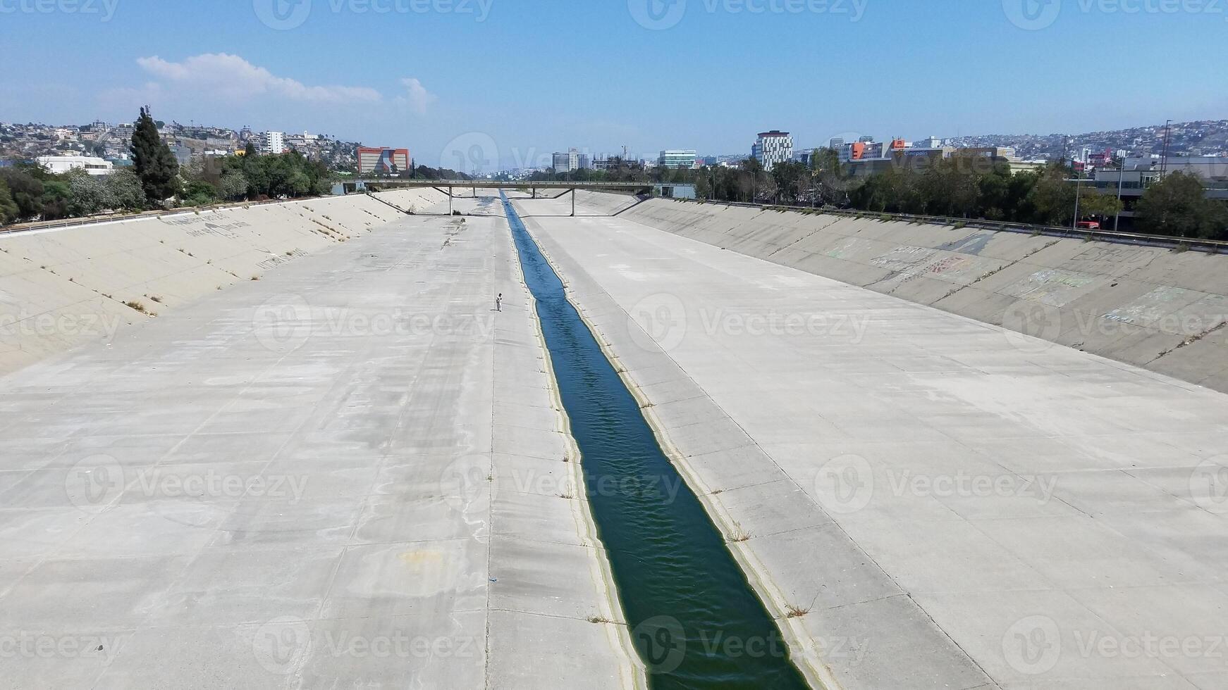 Tijuana River Flowing through a Cement Canal in Tijuana, Mexico photo