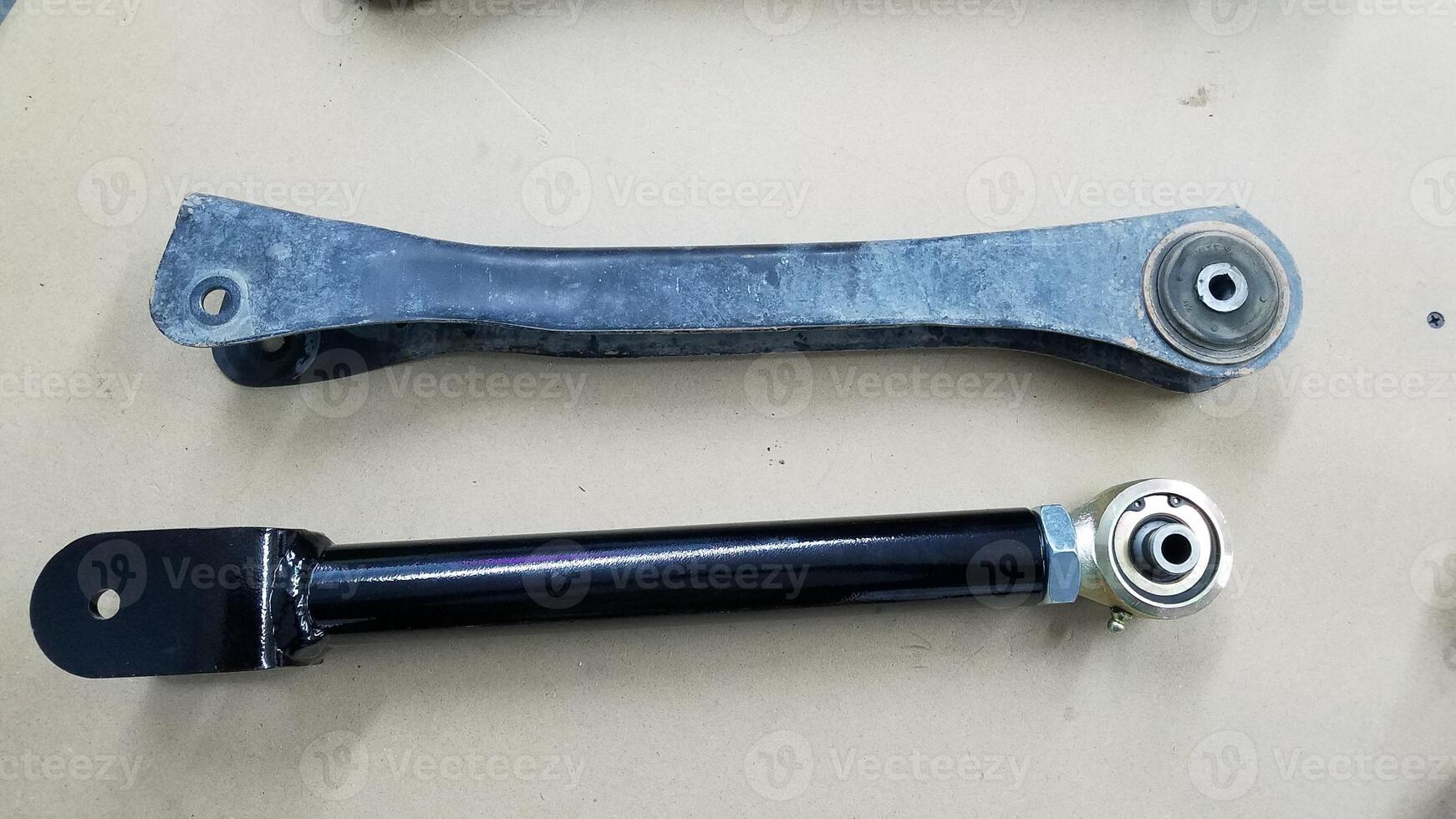 Old and New Control Arms for a 4x4 Vehicle, New one is Adjustable photo