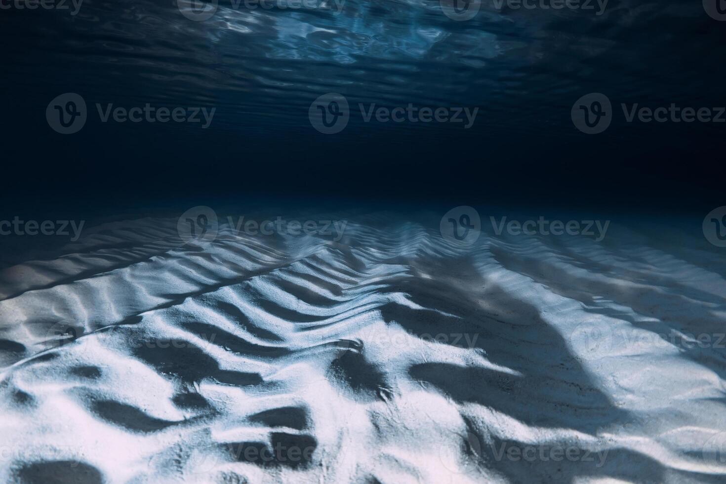 Sand ripples on ocean floor create a serene and abstract underwater seascape photo