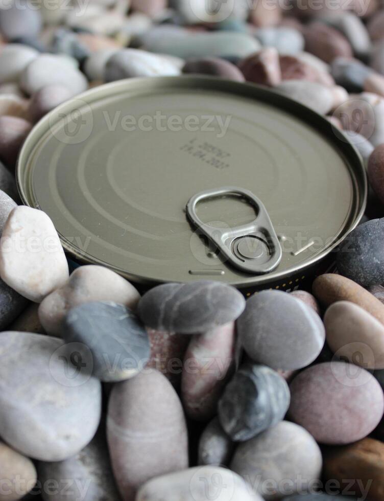 The top lid of the long term can with the key is buried in small pebbles photo