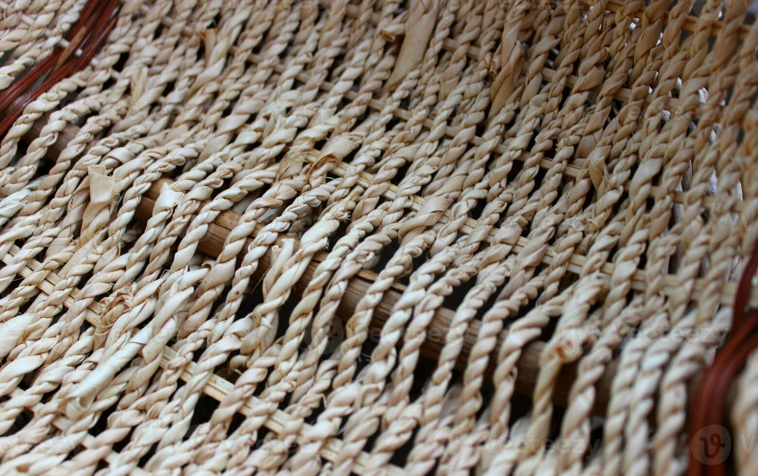 Technique of hand weaving products from twigs in the form of a braid photo