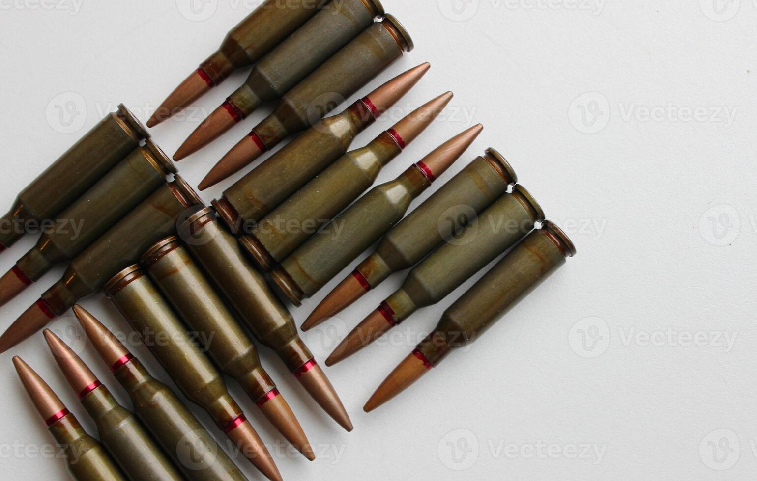 Live cartridges are laid out in a strict geometric shape on white backdrop studio isolated photo