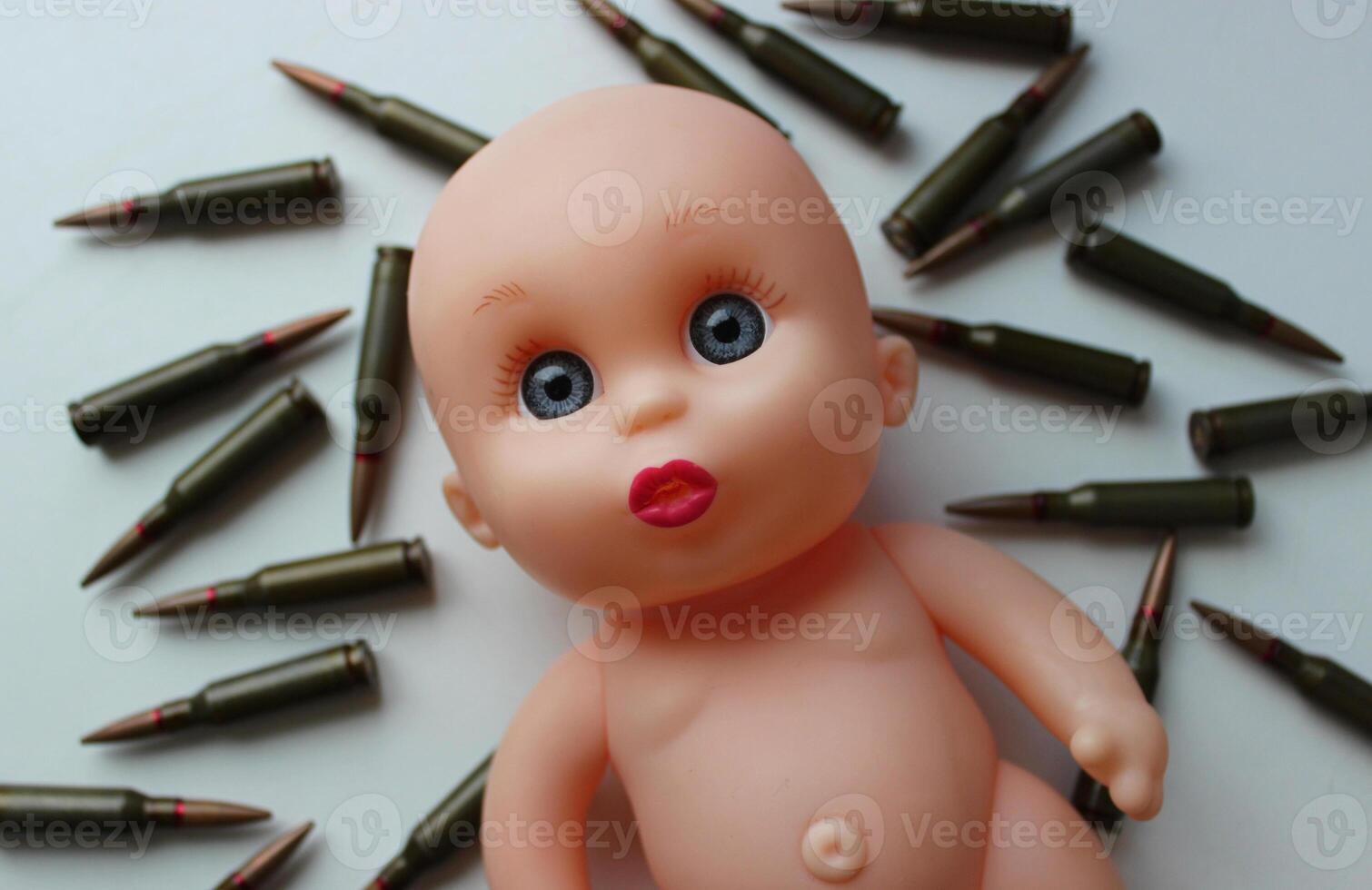 Sad Sight Of Toy Doll Over Ammunition Cartridges. Conceptual Photo On The Topic Of Children Killed In War