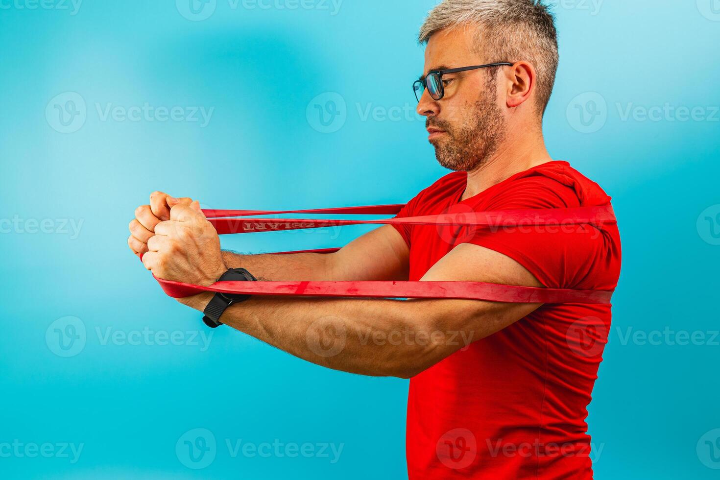 Man exercises with resistance bands at home studio photo