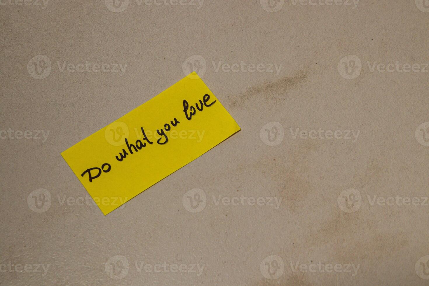 Message on a yellow note encouraging passion and dedication to dreams photo
