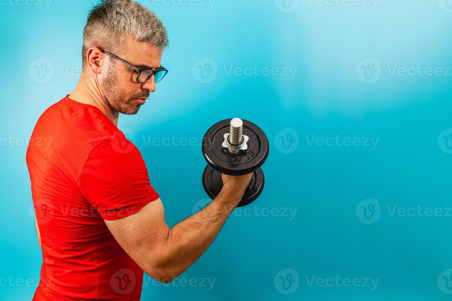 Fitness enthusiast lifting dumbbell in home gym setting photo