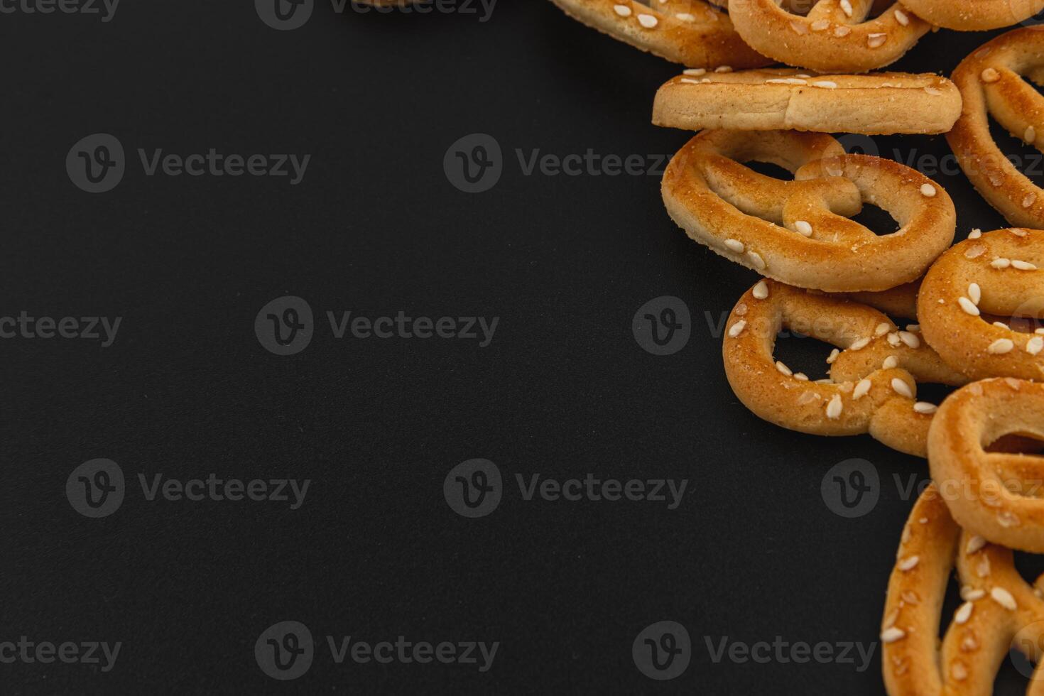 Delicious pretzels scattered on a dark surface ready for snacking at any time photo