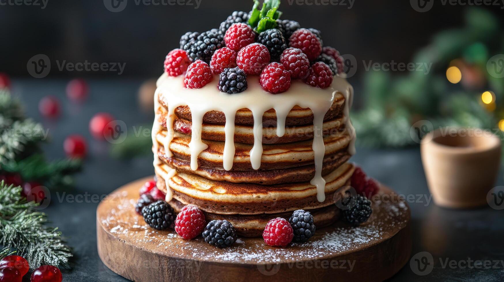 Tall stack of pancakes with white icing drizzle and fresh raspberries and blackberries on wooden board, creating cozy festive mood photo