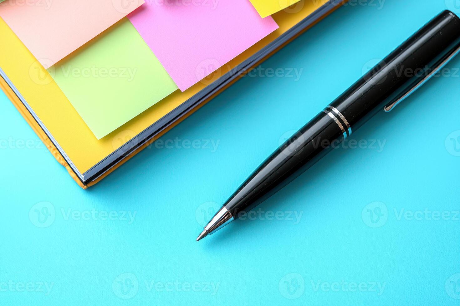 Overhead close up shot of open planner filled with vibrant sticky notes different shapes and colors with sleek black pen resting diagonally pastel. photo