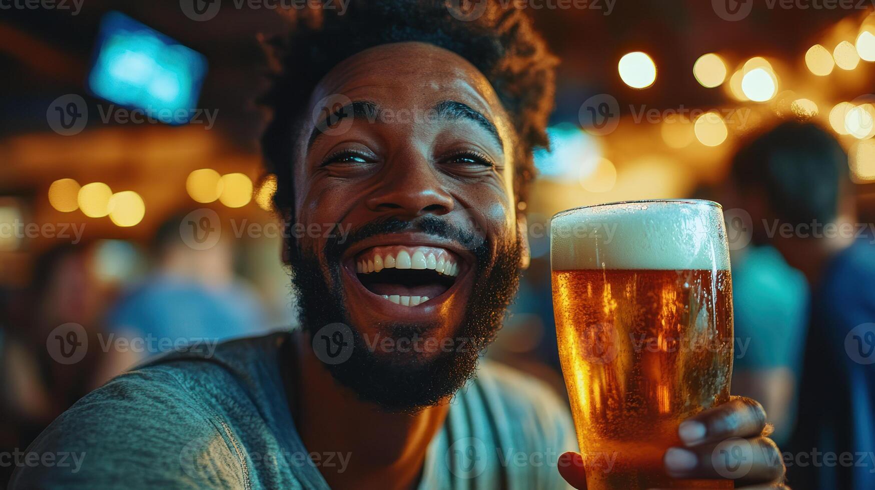 Joyful man laughing with bright eyes holding glass of golden beer in lively bar with warm lights and blurred background photo