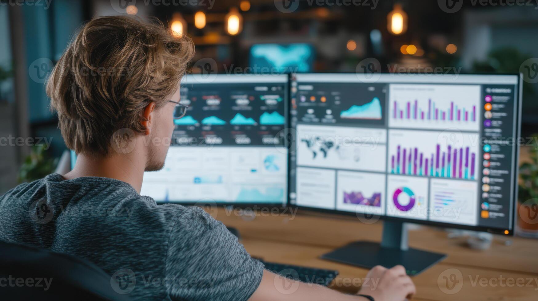 Digital marketing strategist analyzing audience data on dual monitors with charts and graphs in modern office environment photo