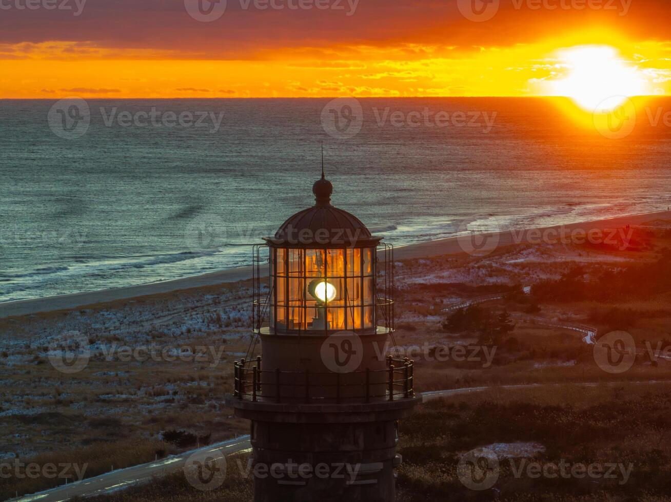 A lighthouse with a light shining in the sky photo